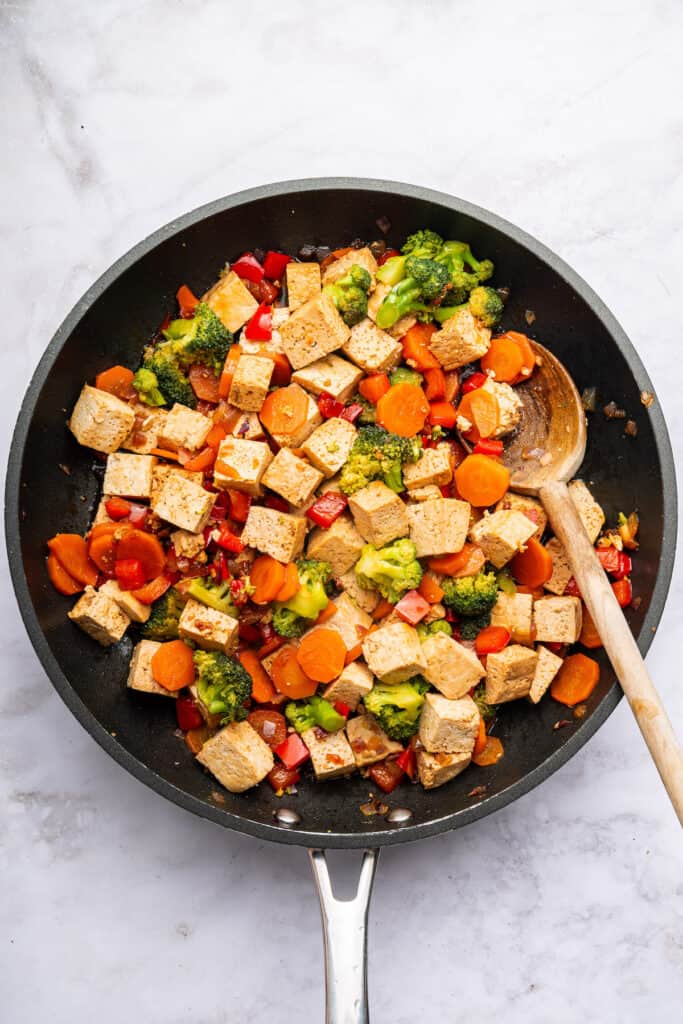 Overhead view of tofu stir fry cooking in pan