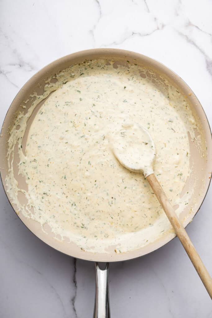 Overhead view of creamy ranch sauce in skillet